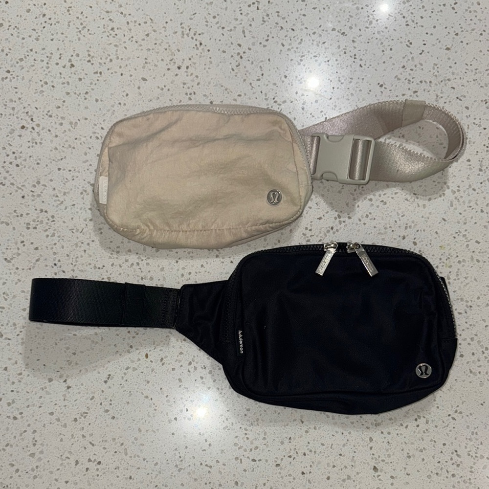 Pair of lululemon crossbody belt bags cream black